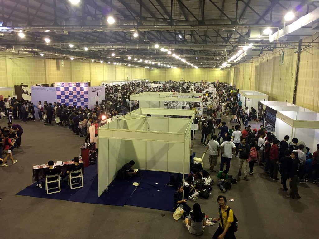 Crowds browsing manga and fan-made comics at a large Japanese comic convention